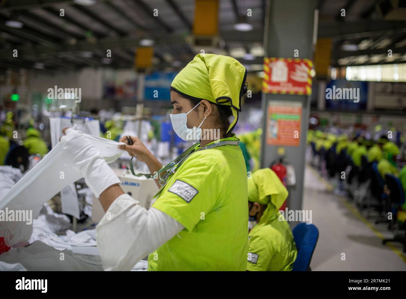 Ready-made garments (RMG) workers working in a LEED Certified Green Garment factory at Adamjee Export Processing Zone in Narayanganj, Bangladesh. Stock Photo