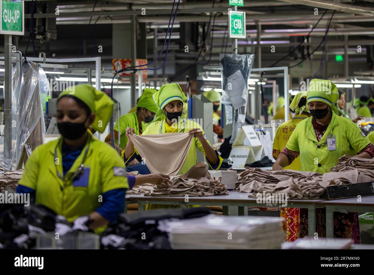 Ready-made garments (RMG) workers working in a LEED Certified Green Garment factory at Adamjee Export Processing Zone in Narayanganj, Bangladesh. Stock Photo