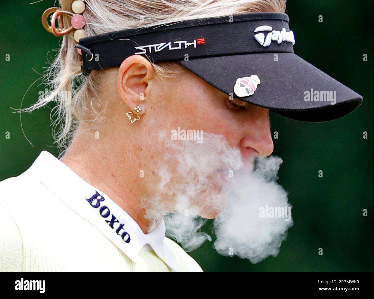 GRAND RAPIDS, MI JUNE 16 LPGA golfer Charley Hull blows smoke from