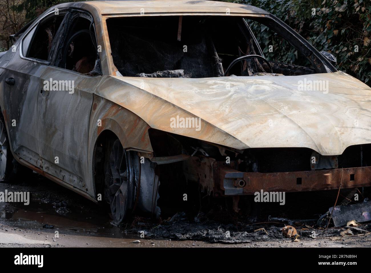 Auto completely burnt by arsonists. Burnt car wreckage, destroyed by arsonists. Vandalism Stock Photo