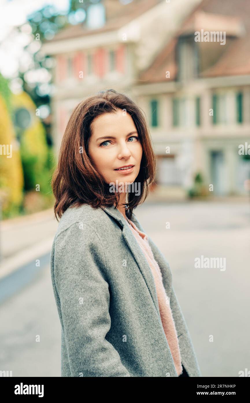 Outdoor portrait of beautiful woman wearing grey coat Stock Photo - Alamy