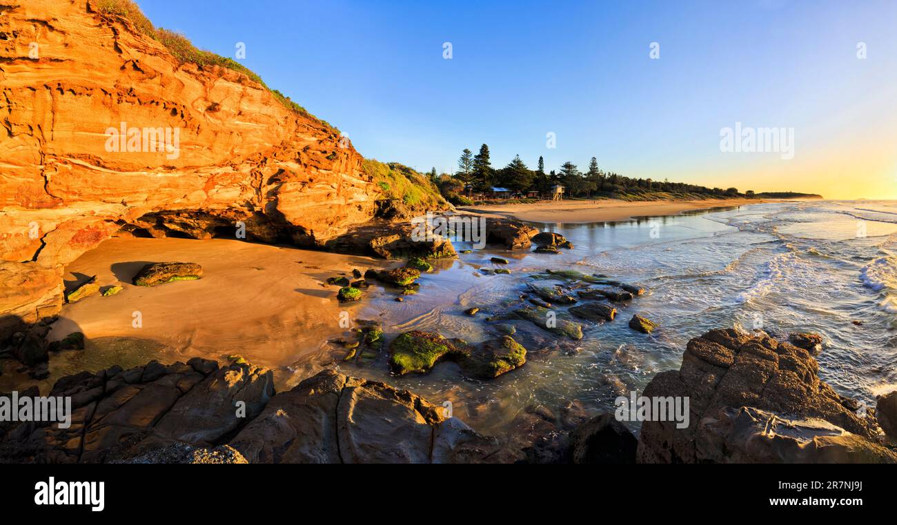 Caves beach scenic seascape panorama at sunrise from mouth of sea cave. Stock Photo