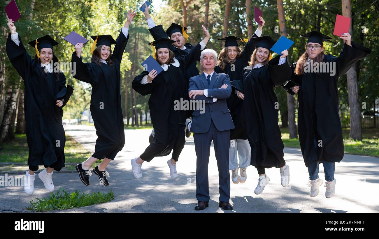 Image result for A university professor and seven robed graduates are jumping outdoors ...