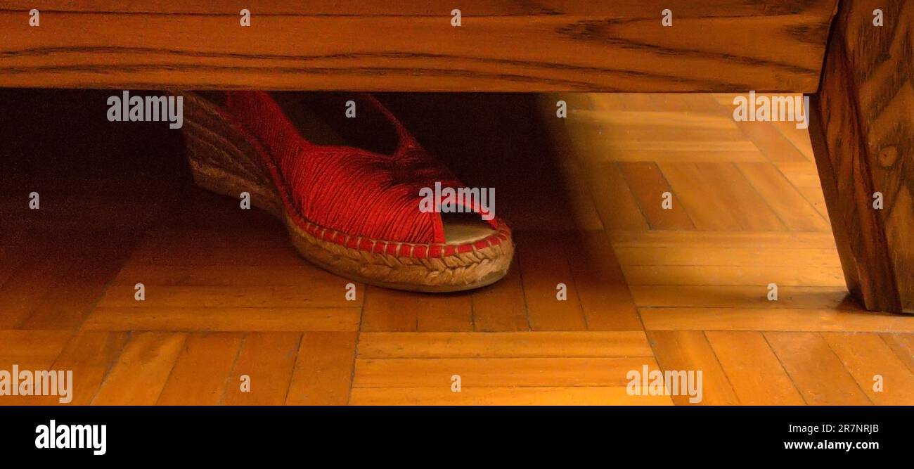 Lost womans red shoe under bed Stock Photo