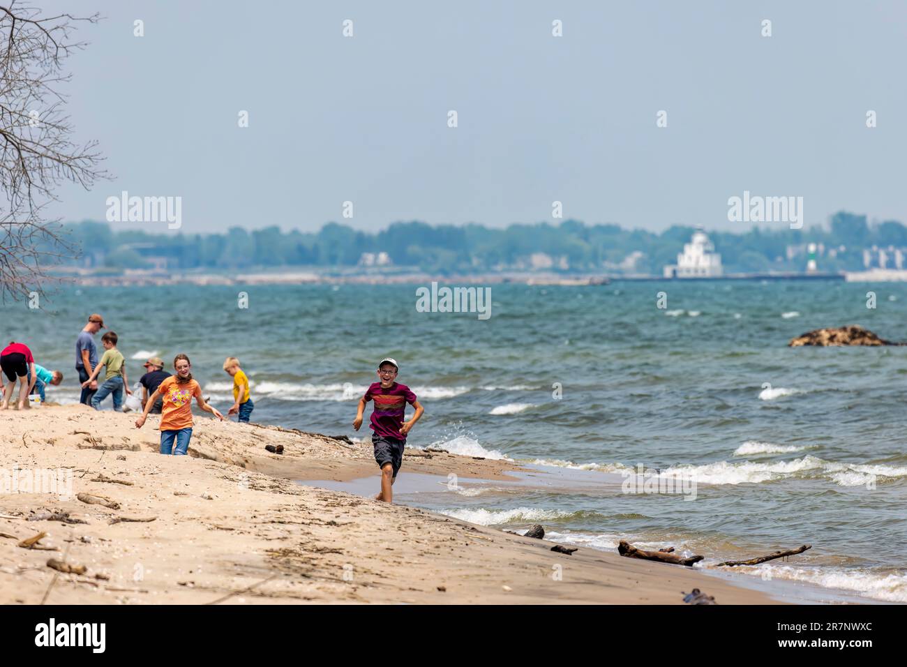 Manitowoc, WI USA Jun 16 2023: Children and youth play on the beaches and in the shallow waters of Lake Michigan Stock Photo