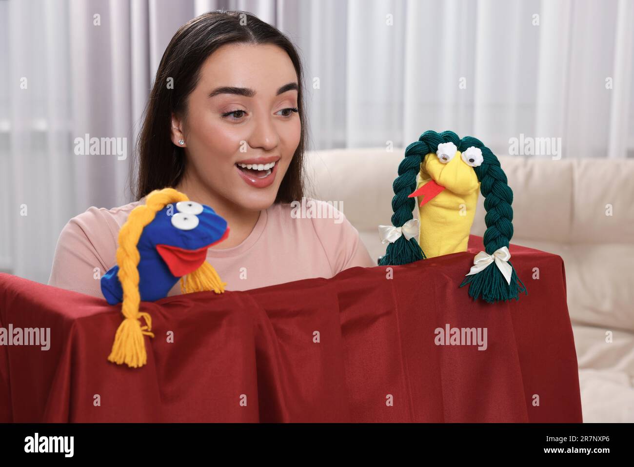 Excited woman performing puppet show at home Stock Photo Alamy