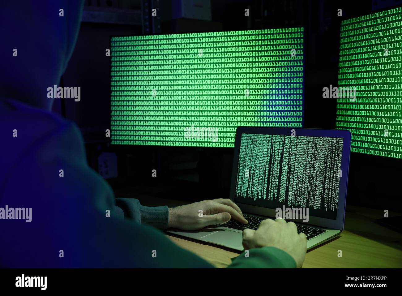Hacker working with computers at wooden table indoors, closeup. Cyber attack Stock Photo
