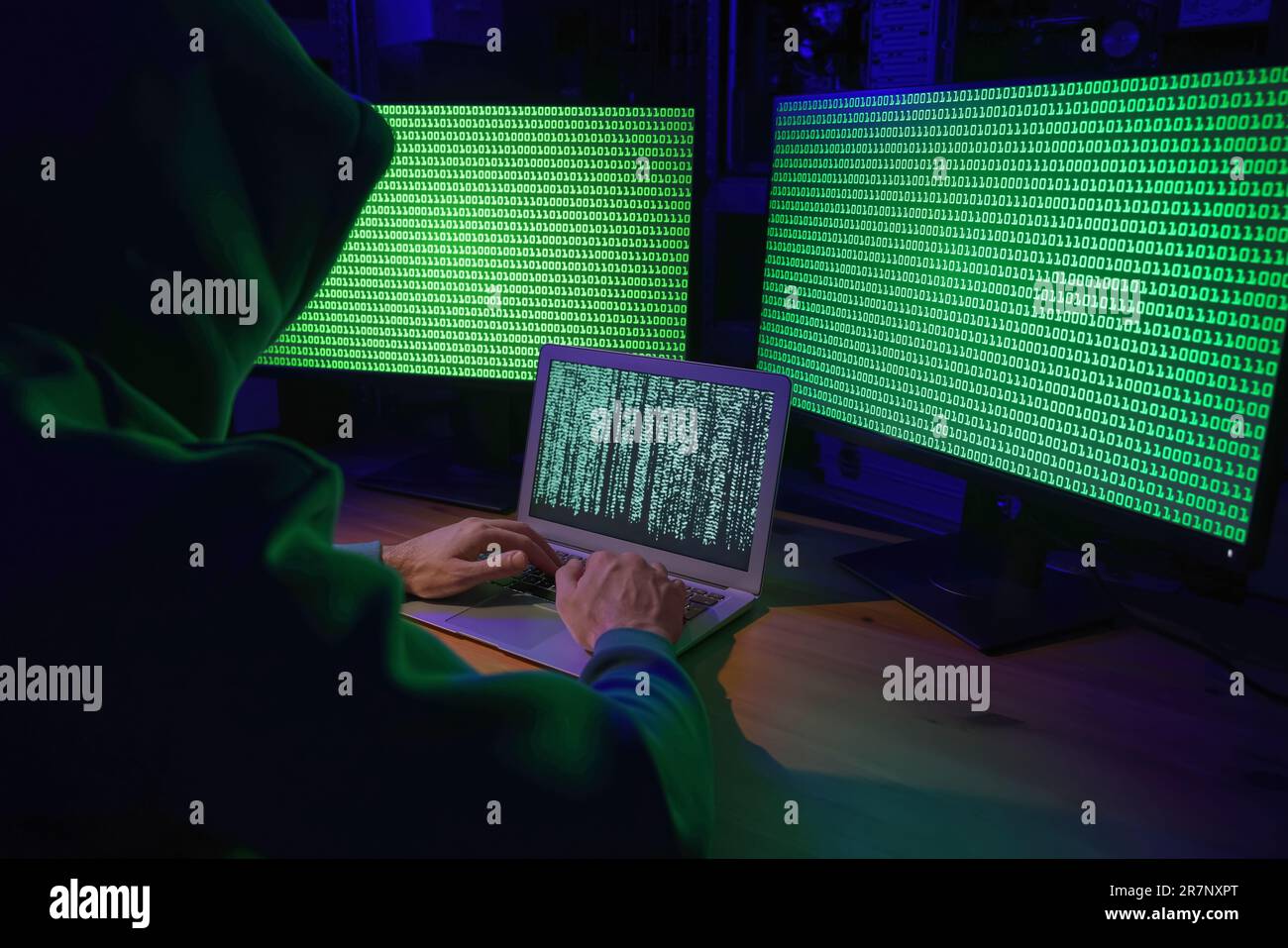 Hacker working with computers at wooden table indoors. Cyber attack ...