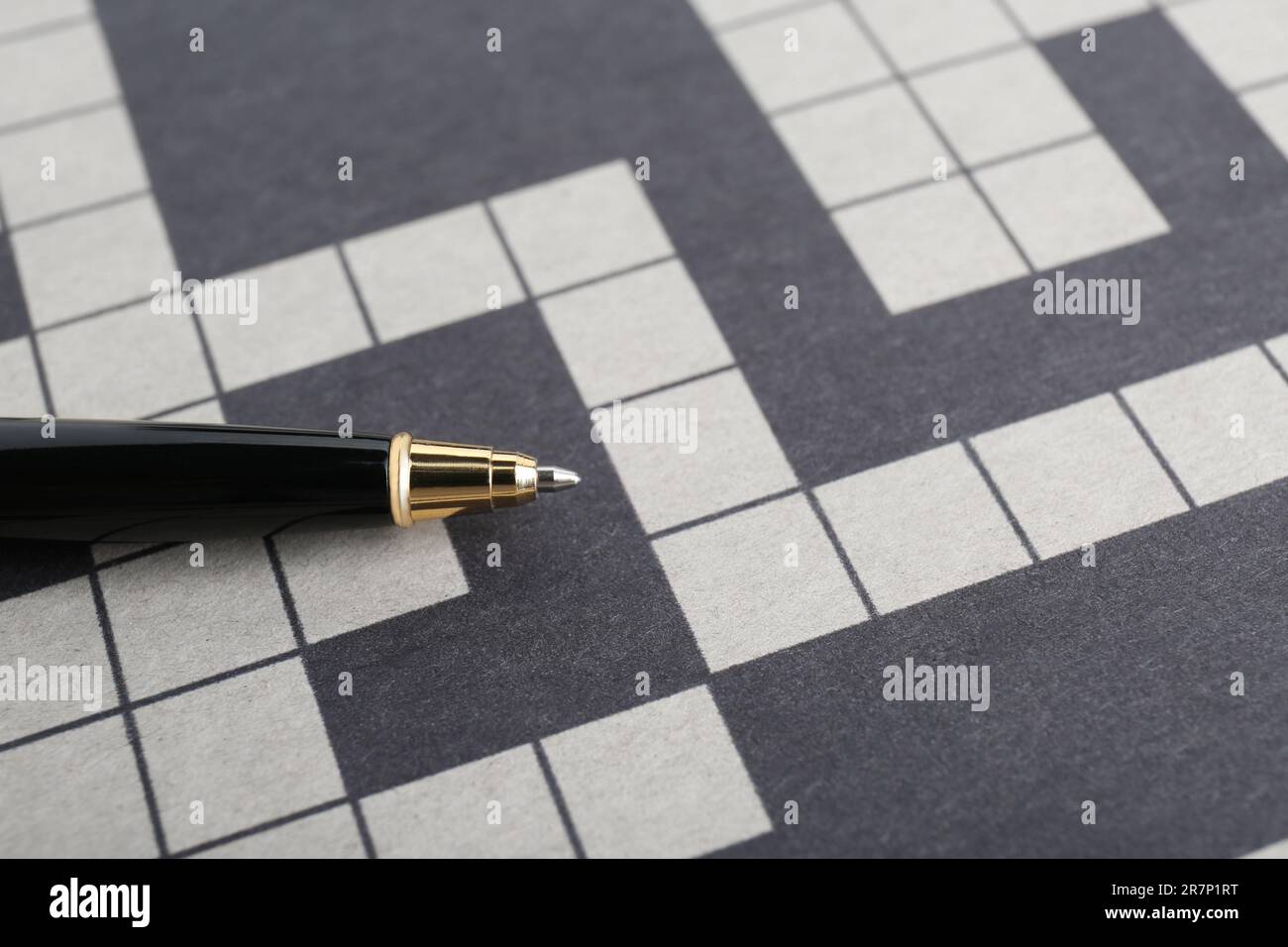 Pen on blank crossword, closeup. Space for text Stock Photo Alamy