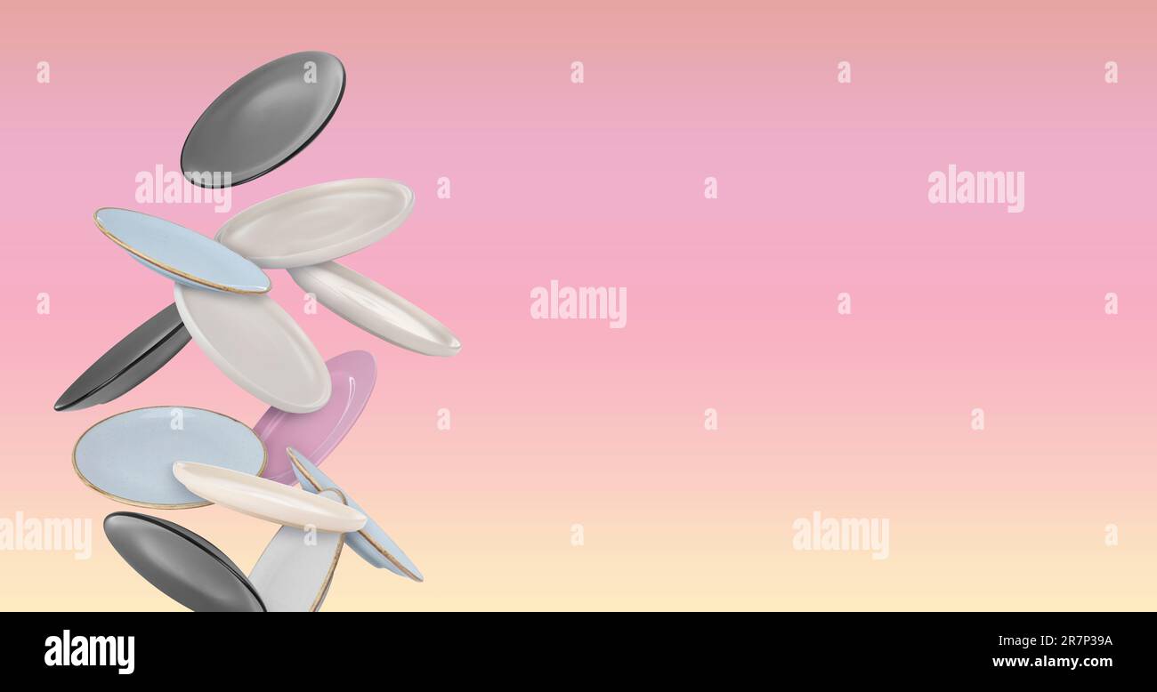 Many different plates falling on pastel yellow pink gradient background ...