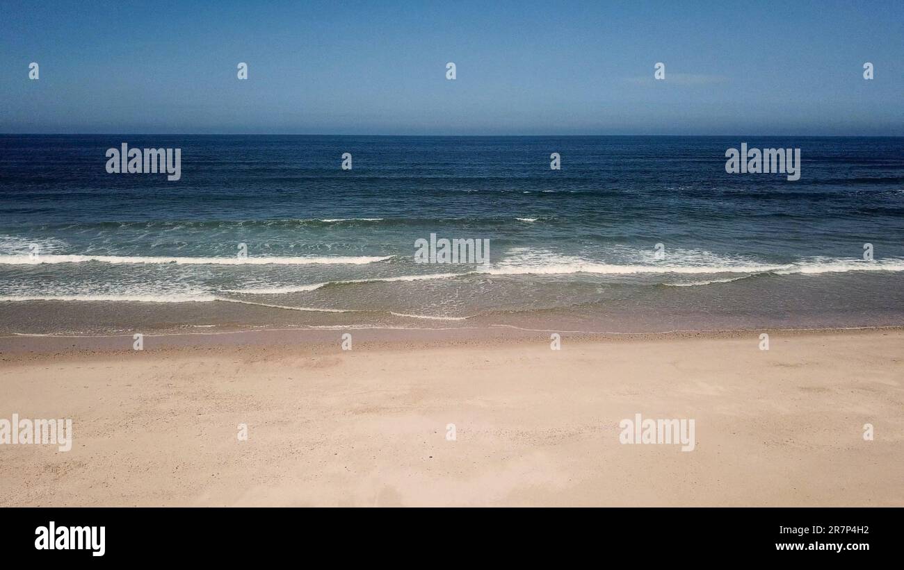 Aerial view of ocean waves crashing on beach, 4K drone footage Stock ...