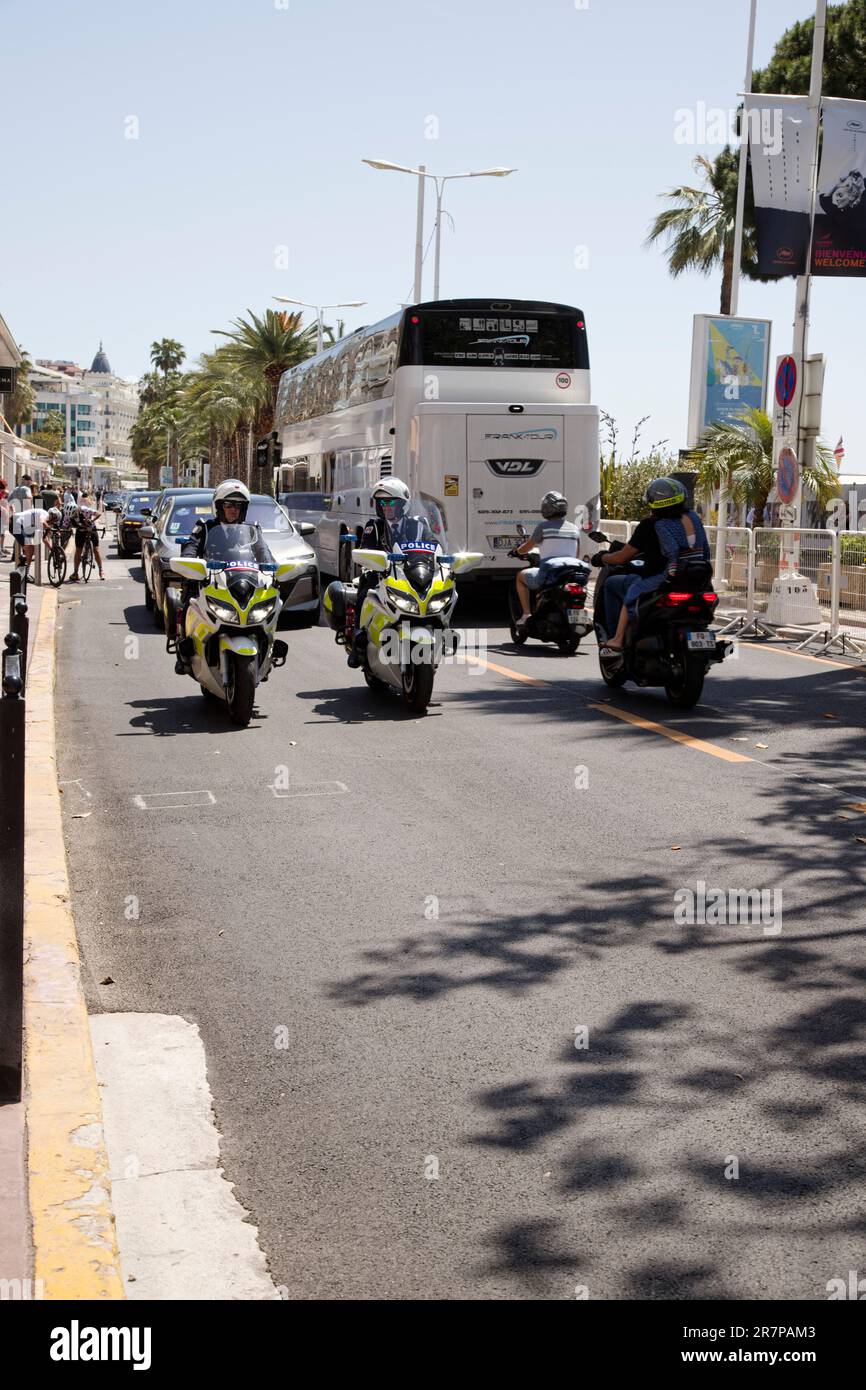 Personalities accompanied to the Palais des Festivals by police on motorbikes during the 76th Annual Cannes Film Festival Stock Photo