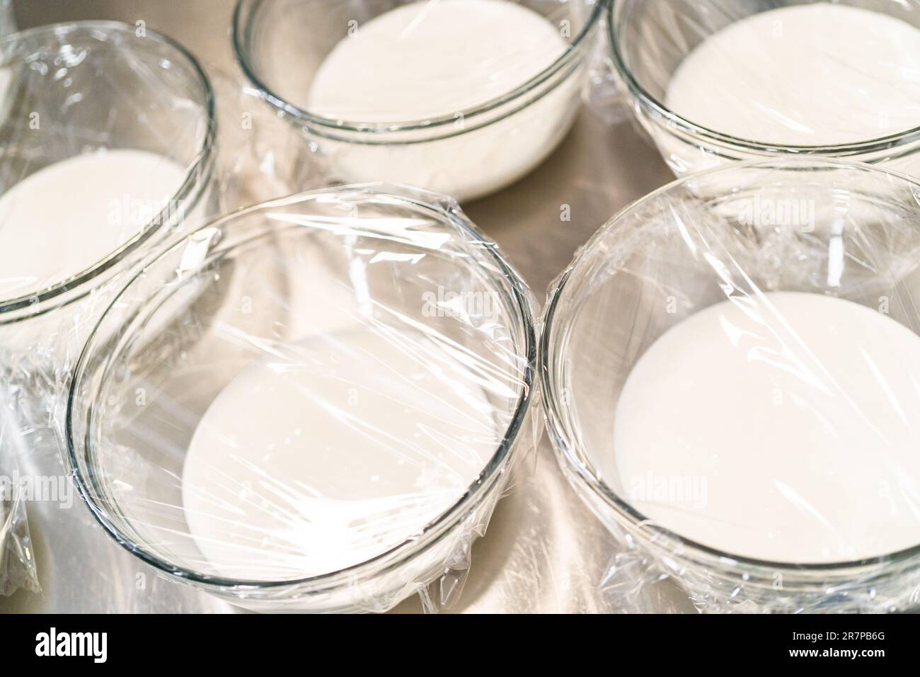 Glass mixing bowls with white royal icing Stock Photo Alamy