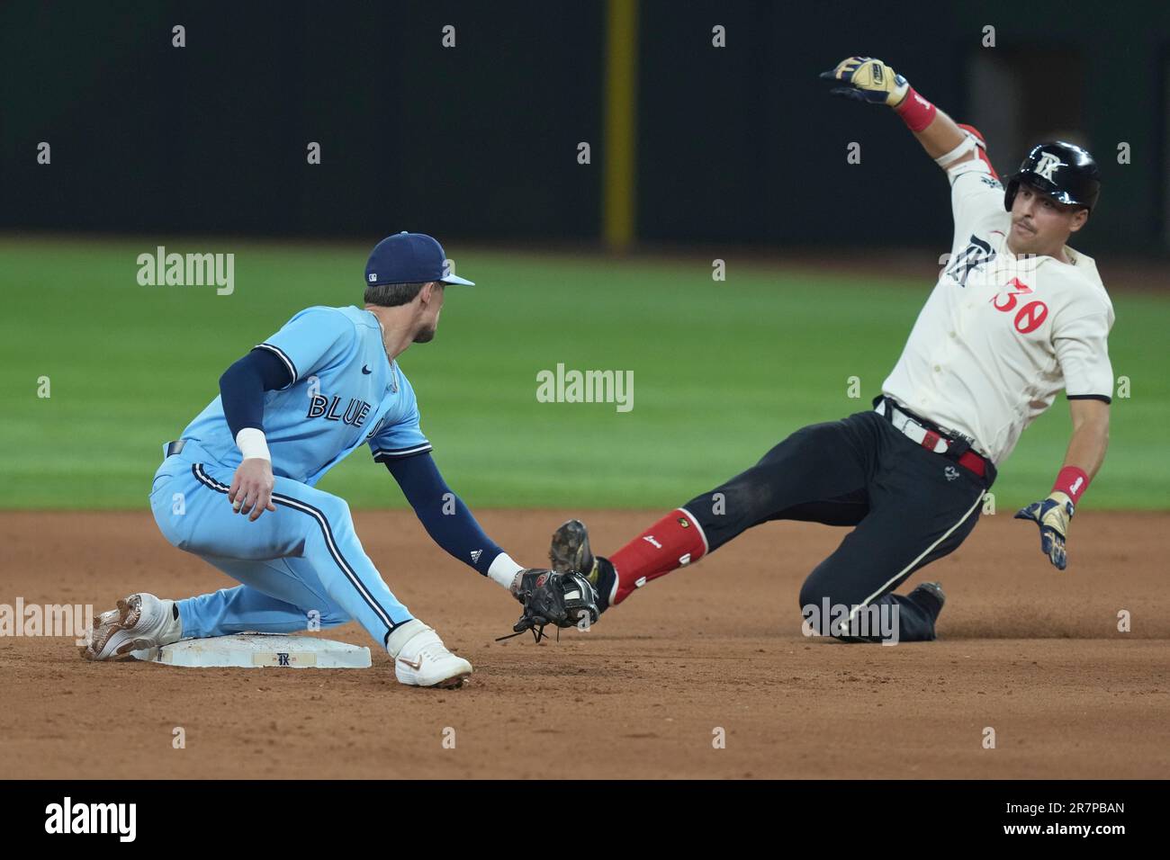 Texas Rangers' Nathaniel Lowe (30) is tagged out by Toronto Blue Jays  second baseman Cavan Biggio (8) during the 8th inning of a baseball game in  Arlington, Texas, Friday, June 16, 2023.