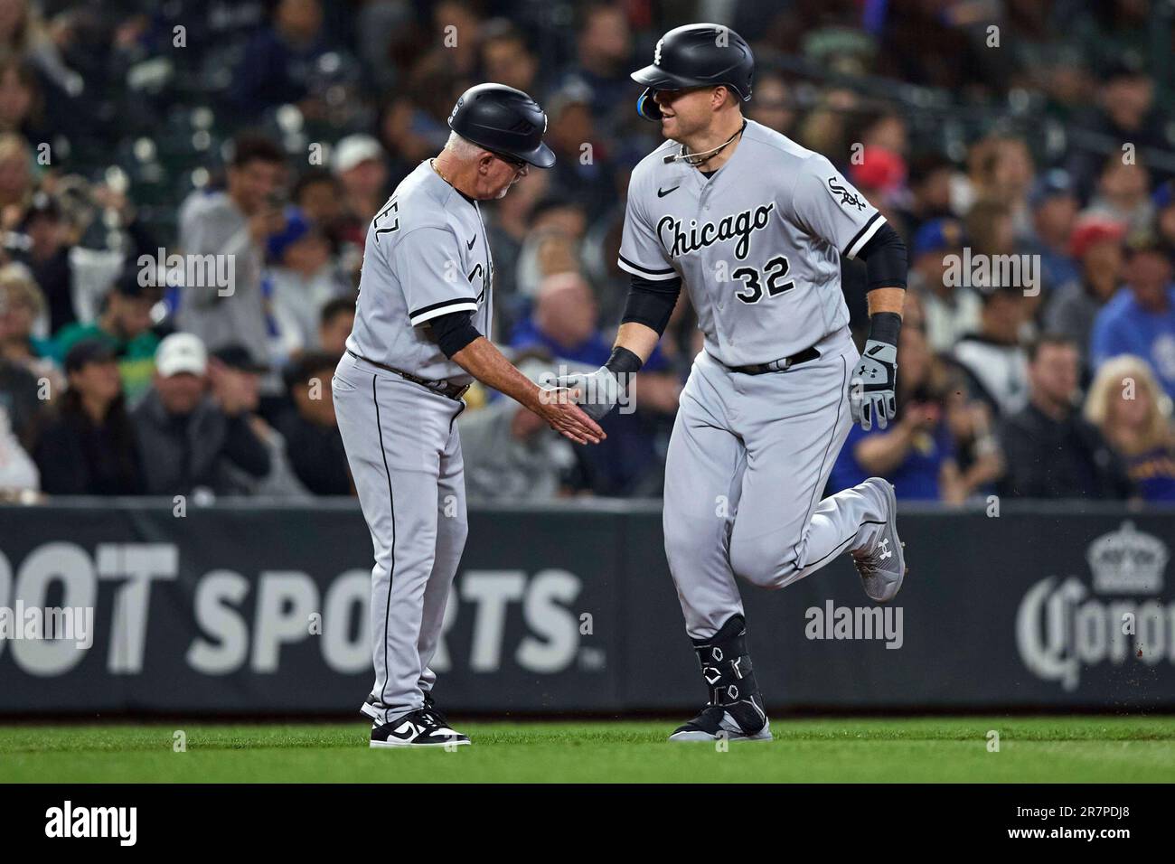 Chicago White Sox's Gavin Sheets is greeted by third base coach Eddie