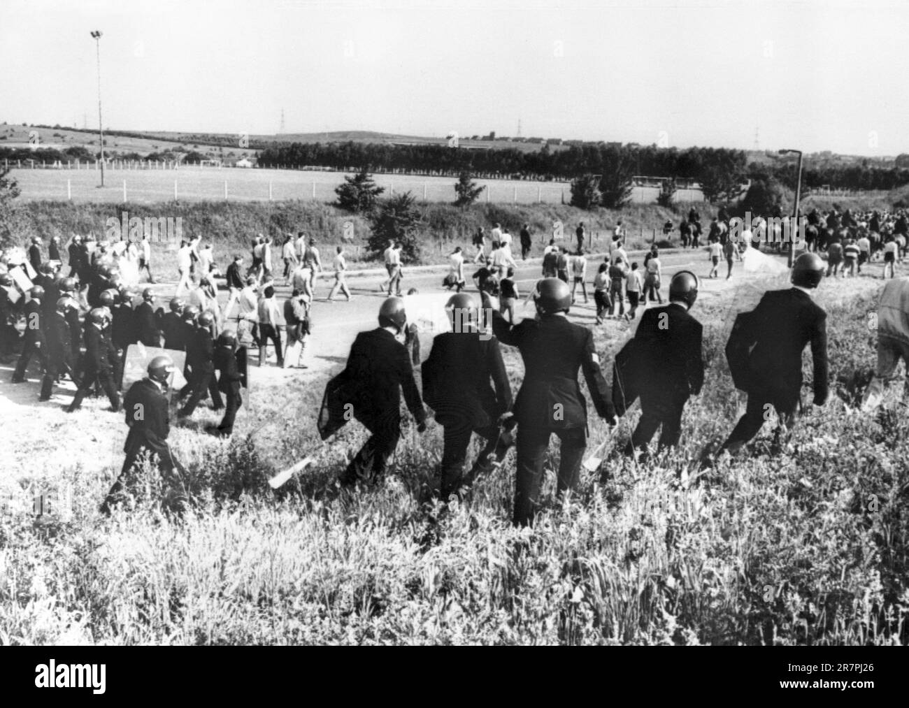 File photo dated 18/6/1984 of police in anti-riot gear escorting picketers away from their position near the Orgreave Coking Plant near Rotherham. Thousands of people will join a protest on Saturday to keep up the pressure for an inquiry into one of the most violent clashes of the miners' strike 39 years ago. Issue date: Saturday June 17, 2023. Stock Photo