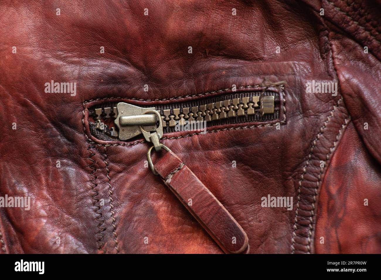 leather red background with zipper on it close up Stock Photo