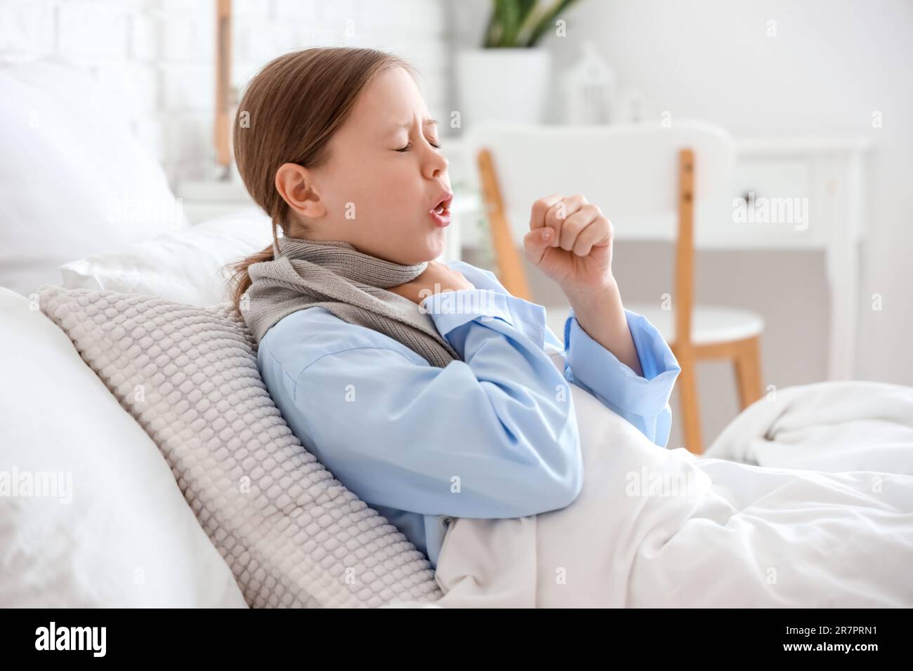 Ill little girl coughing in bedroom Stock Photo Alamy