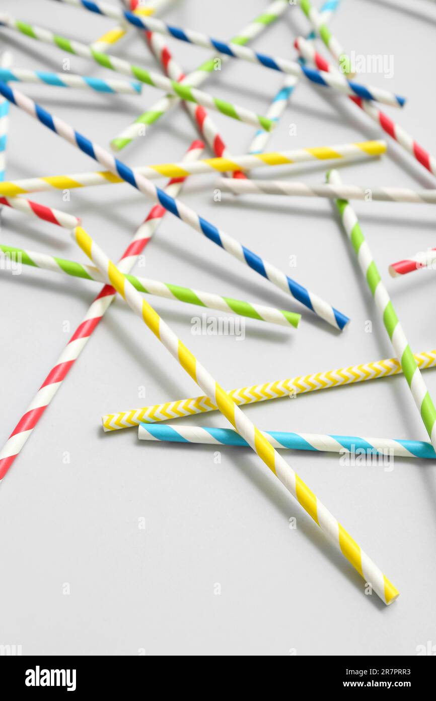 Different paper drinking straws on blue background Stock Photo