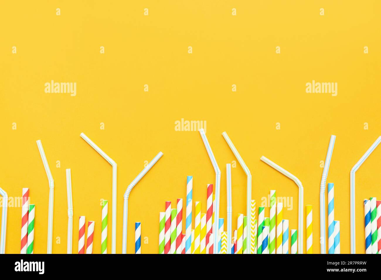 Different drinking straws on orange background Stock Photo