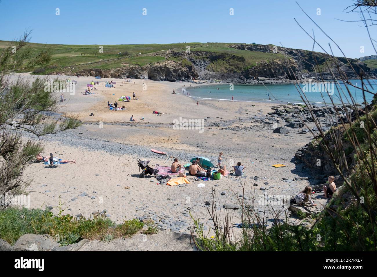 Holiday makers on the beach at Gunwalloe and Dollar coves on the south coast of Cornwall, England. Stock Photo