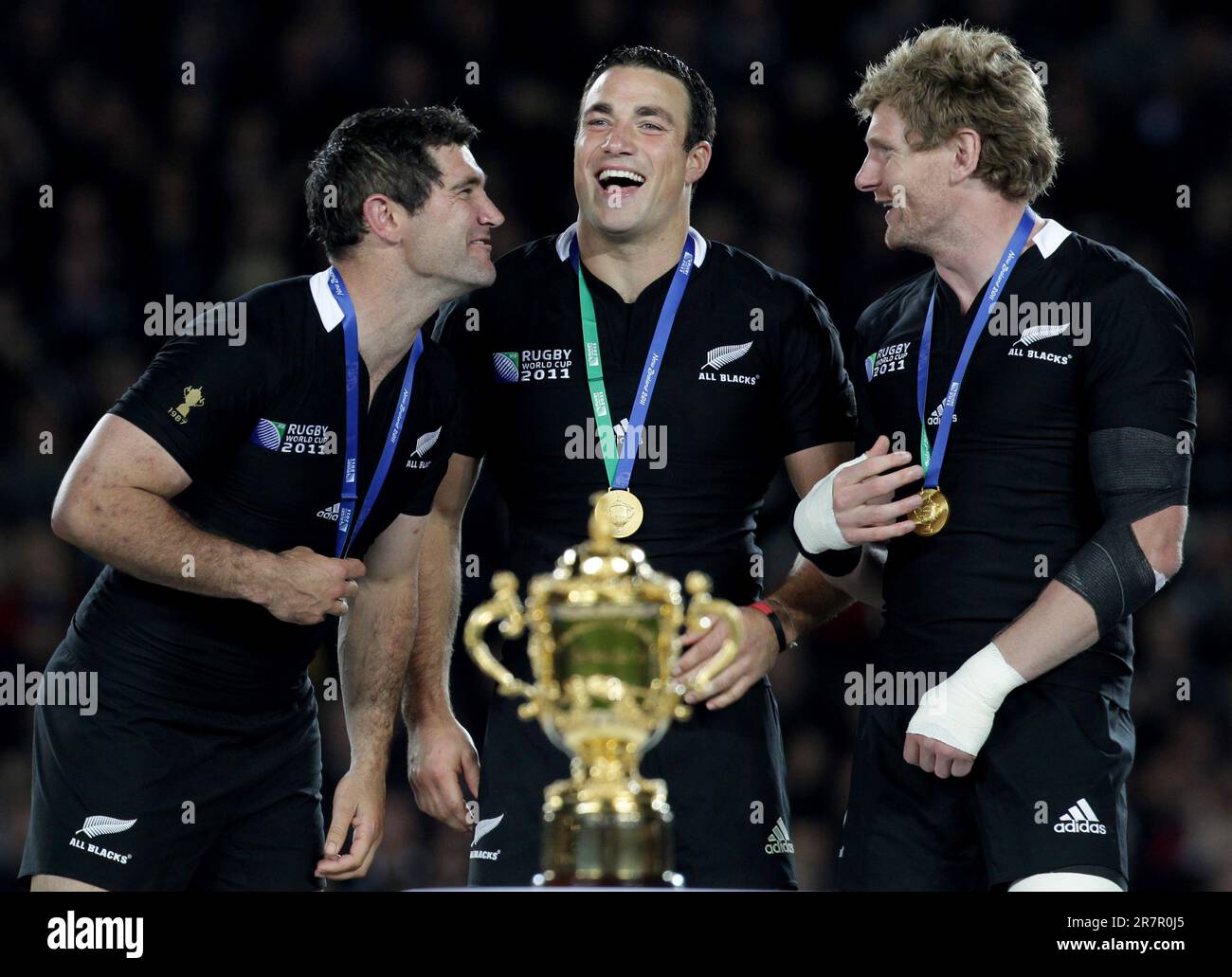 (L-R) New Zealand’s Stephen Donald, Richard Kahui and Adam Thomson celebrate defeating France in the Rugby World Cup final at Eden Park, Auckland, New Zealand, Sunday, October 23, 2011. Stock Photo