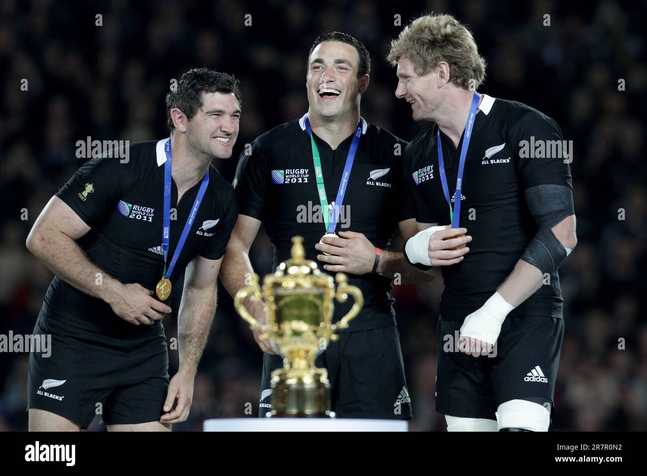 (L-R) New Zealand’s Stephen Donald, Richard Kahui, Adam Thompson, celebrate after defeating France in the Rugby World Cup final at Eden Park, Auckland, New Zealand, Sunday, October 23, 2011. Stock Photo