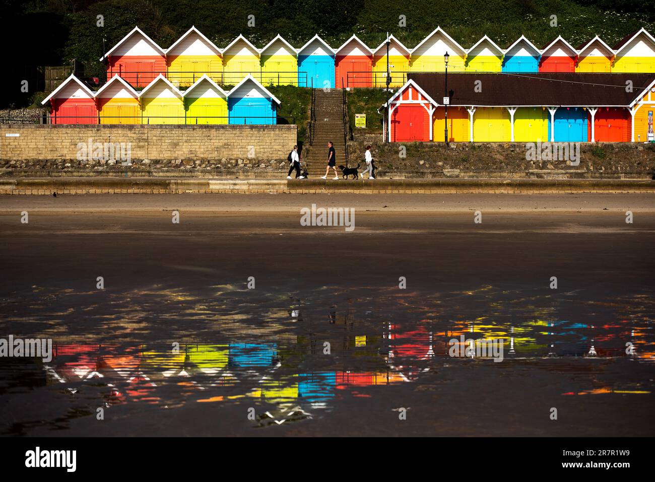 Scarborough, North Yorkshire, UK. 17th June 2023. People soak up the early morning light in front of the beach huts at North Bay, Scarborough, North Yorkshire. Neil Squires/Alamy Live News Stock Photo