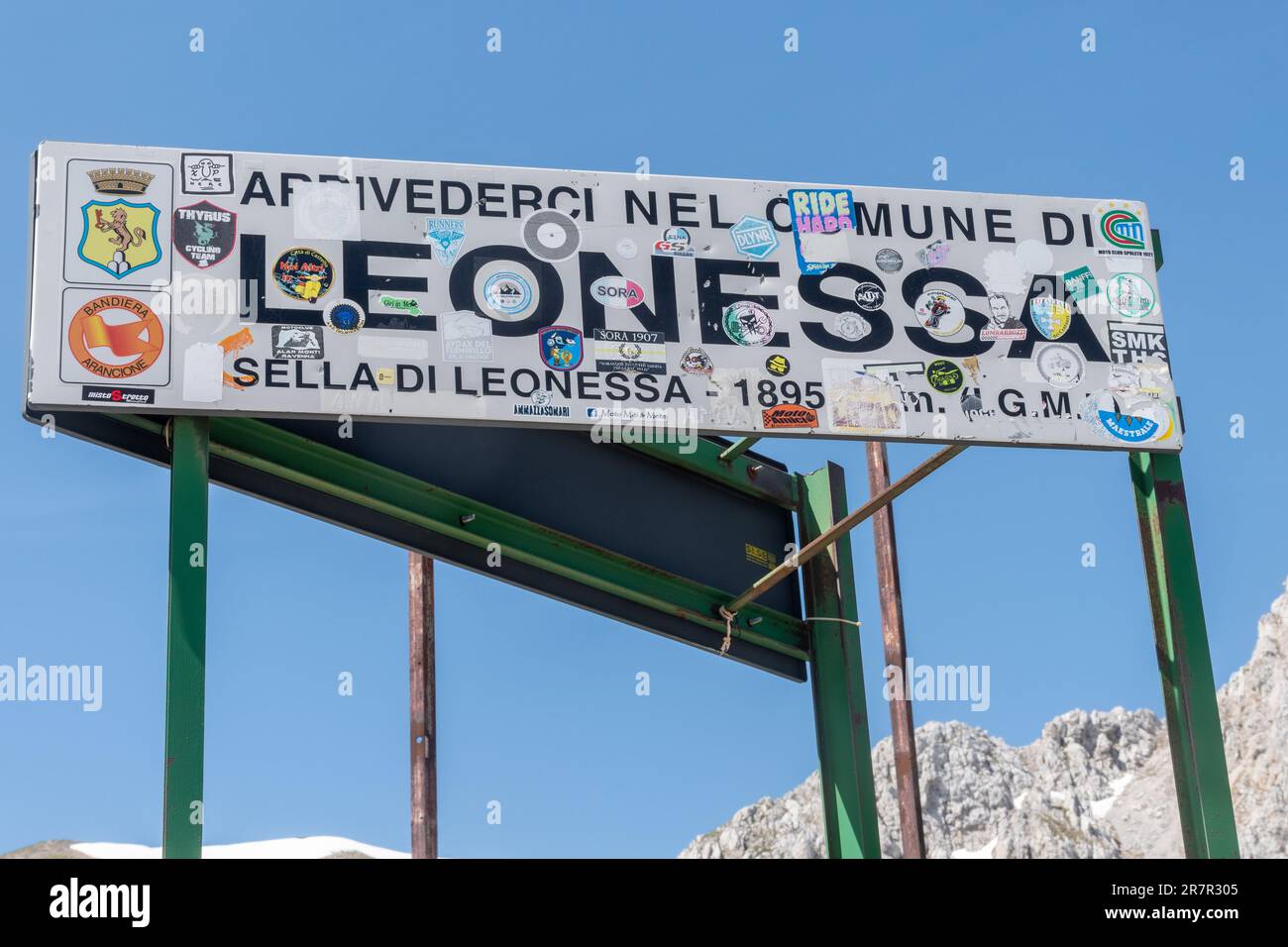 Leonessa road sign covered with motorcycle club stickers, Lazio, Italy, Europe. This sign in the Apennines is becoming illegible. Theme vandalism Stock Photo