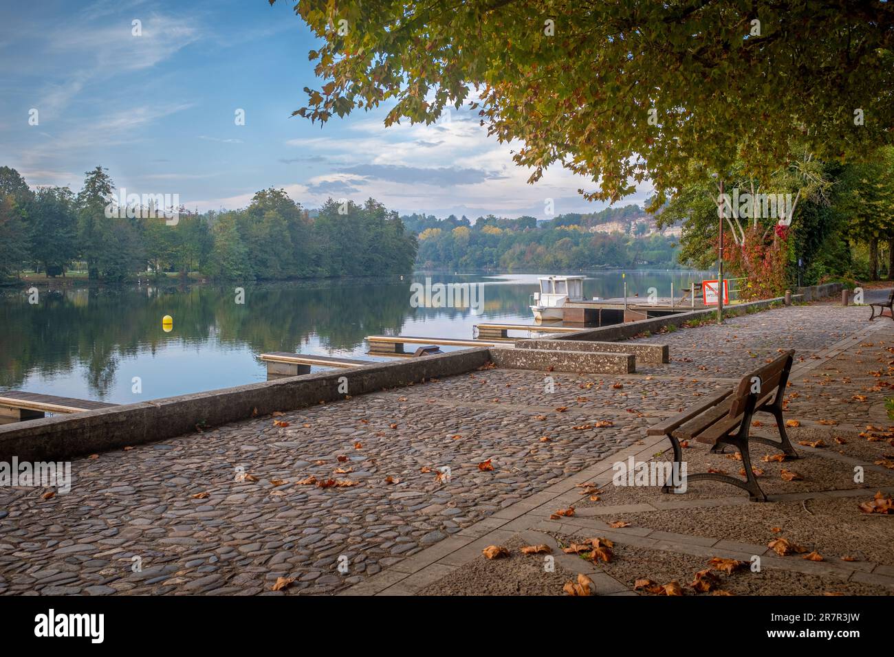 Lot river seen from Cajarc, Southwest France, taken with a bench in the foreground on a sunny autumn morning with no people Stock Photo