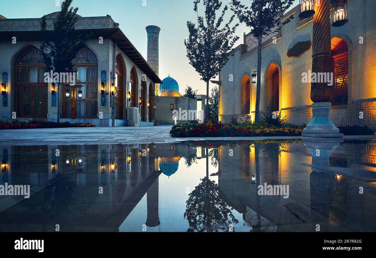 Samarkand Eternal city Boqiy Shahar Registan public square with mosque and minaret modern complex of ancient city with reflection and colorful illumin Stock Photo