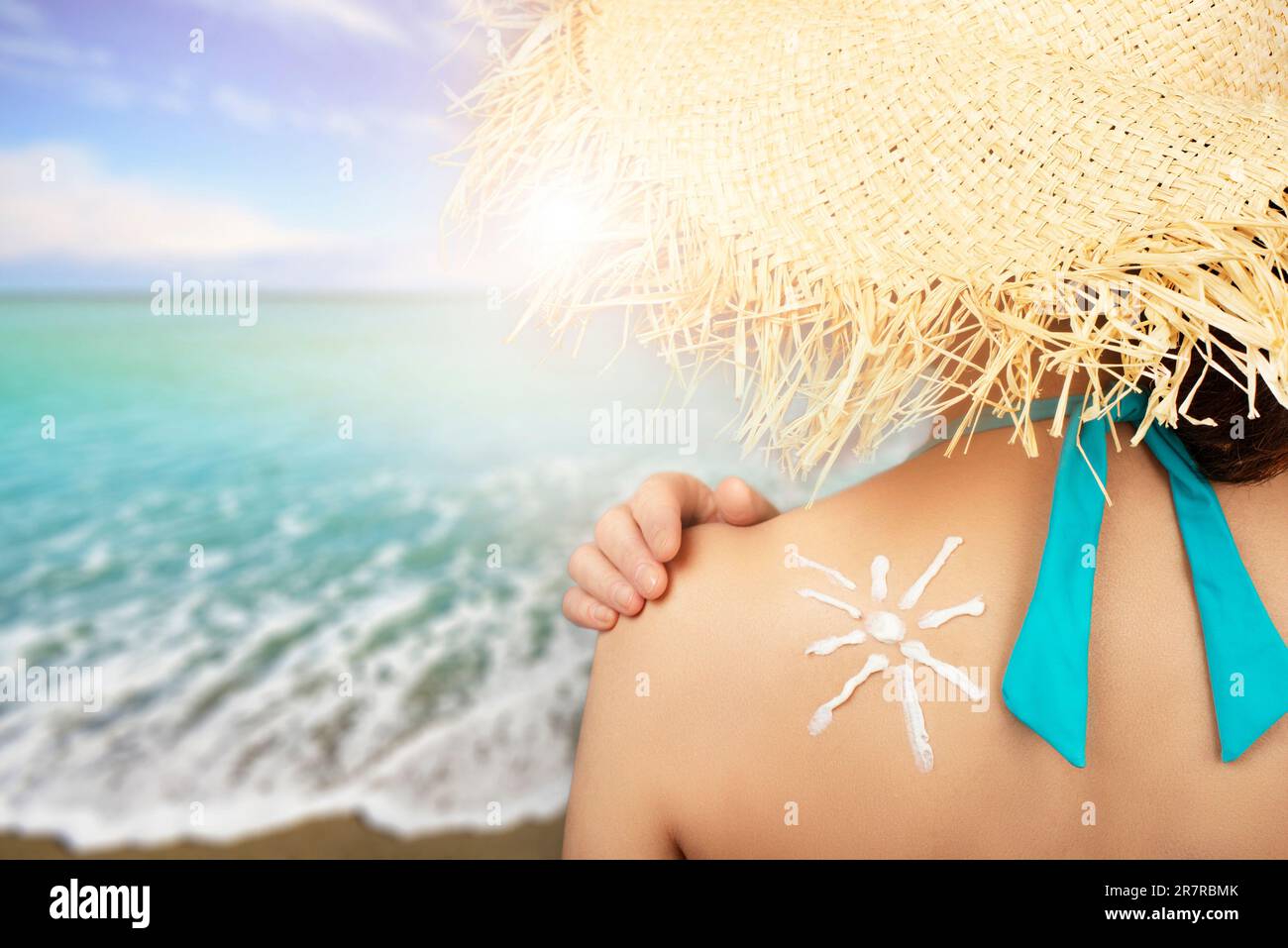 Middle aged caucasian female model applying sunscreen. Stock Photo