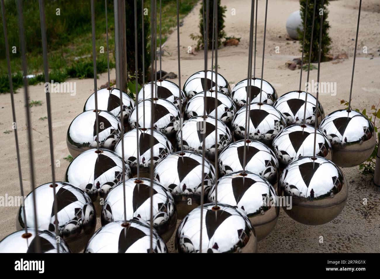 triangular metal large newton balls in a garden. Stock Photo
