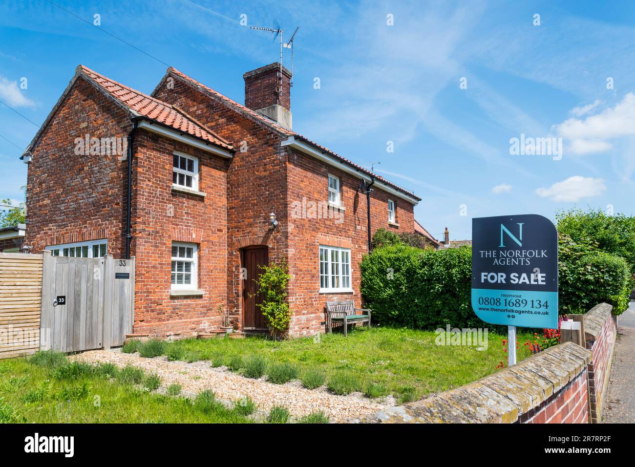 A For Sale sign on a semidetached house in the Norfolk village of