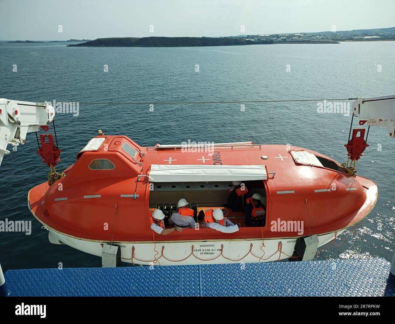 lounging life boat from a ship with crew,life boat lounging,,safety,life saving appliances