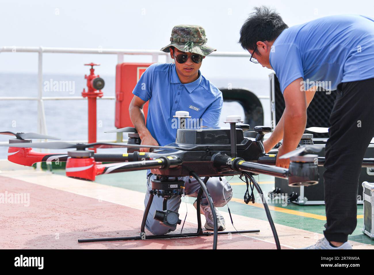 (230617) -- HAIKOU, June 17, 2023 (Xinhua) -- Staff members test an unmanned aerial vehicle for conducting an open-sea testing of the low-Earth orbit broadband communication test constellation at the 'Dian Ke No.1' comprehensive test ship, June 15, 2023.  Researchers from the GalaxySpace, a Beijing-based satellite maker, and several scientific research institutions, conducted an open-sea testing of the country's first low-Earth orbit broadband communication test constellation in the South China Sea. The testing aims to verify the collaborative communication coverage ability of high-Earth orbit Stock Photo