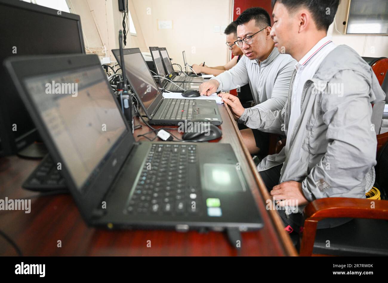 (230617) -- HAIKOU, June 17, 2023 (Xinhua) -- Staff members work to verify the collaborative communication coverage ability of high-Earth orbit and low-Earth orbit satellites, and unmanned aerial vehicles at the 'Dian Ke No.1' comprehensive test ship, June 15, 2023. Researchers from the GalaxySpace, a Beijing-based satellite maker, and several scientific research institutions, conducted an open-sea testing of the country's first low-Earth orbit broadband communication test constellation in the South China Sea. The testing aims to verify the collaborative communication coverage ability of high  Stock Photo