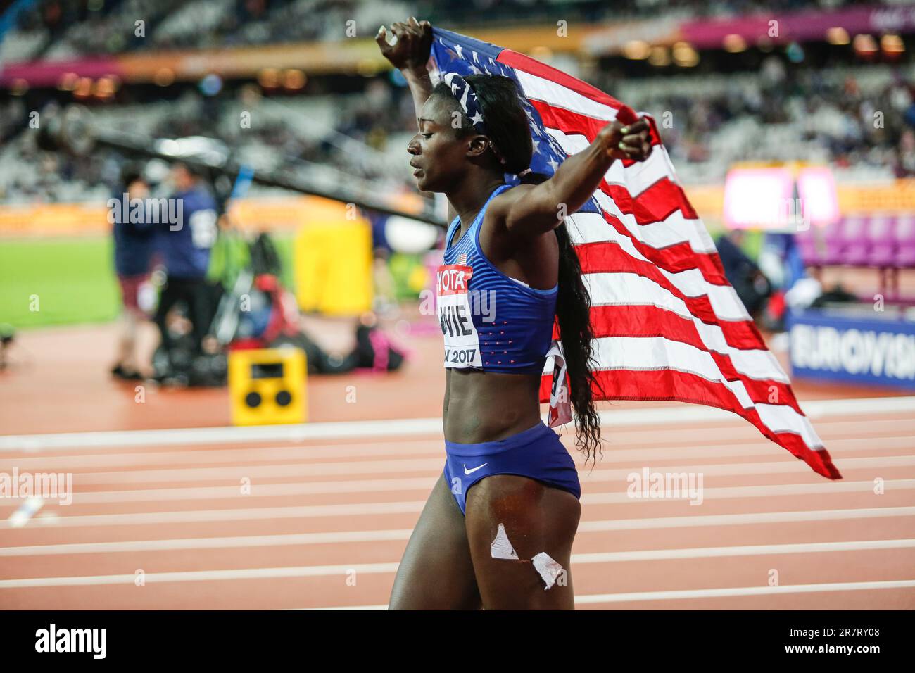 Tori Bowie with her country's flag after winning the 100m at the World Athletics Championships