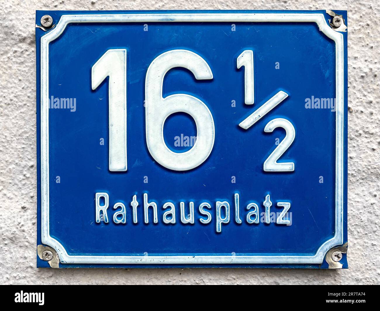Blue enamel plate with the house number sixteen and half at the town