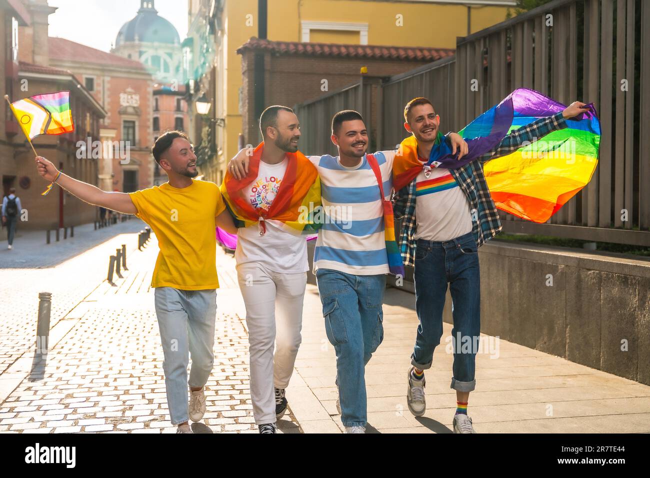 Couples of men having fun at the demonstration with the rainbow flags, gay pride party in the city, lgbt concept Stock Photo