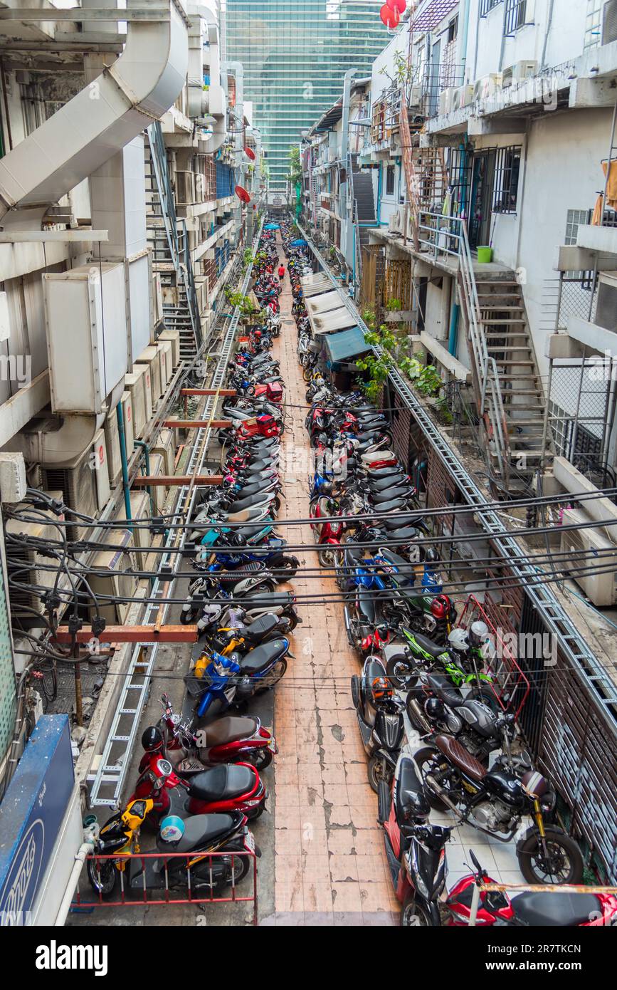 Pathum Rd Street Backyard street with plenty of parked scooters and motorcycles in the ...