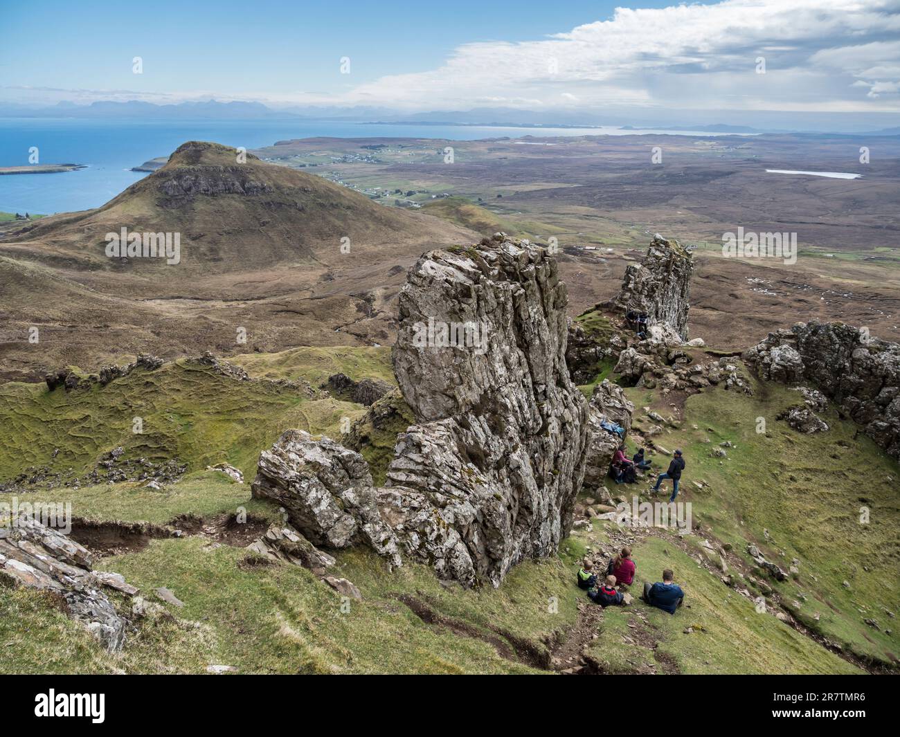 Tourists take a break, hike at Quiraing rock formations, Trotternish peninsula, Isle of Skye, Scotland, UK Stock Photo