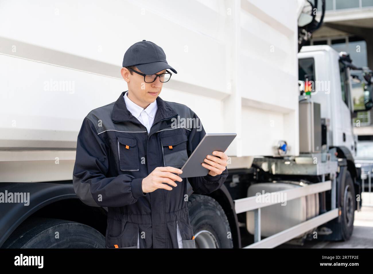 Manager with a digital tablet next to garbage truck.. Stock Photo