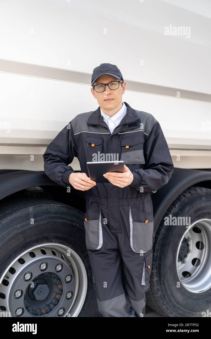 Manager with a digital tablet next to garbage truck.. Stock Photo