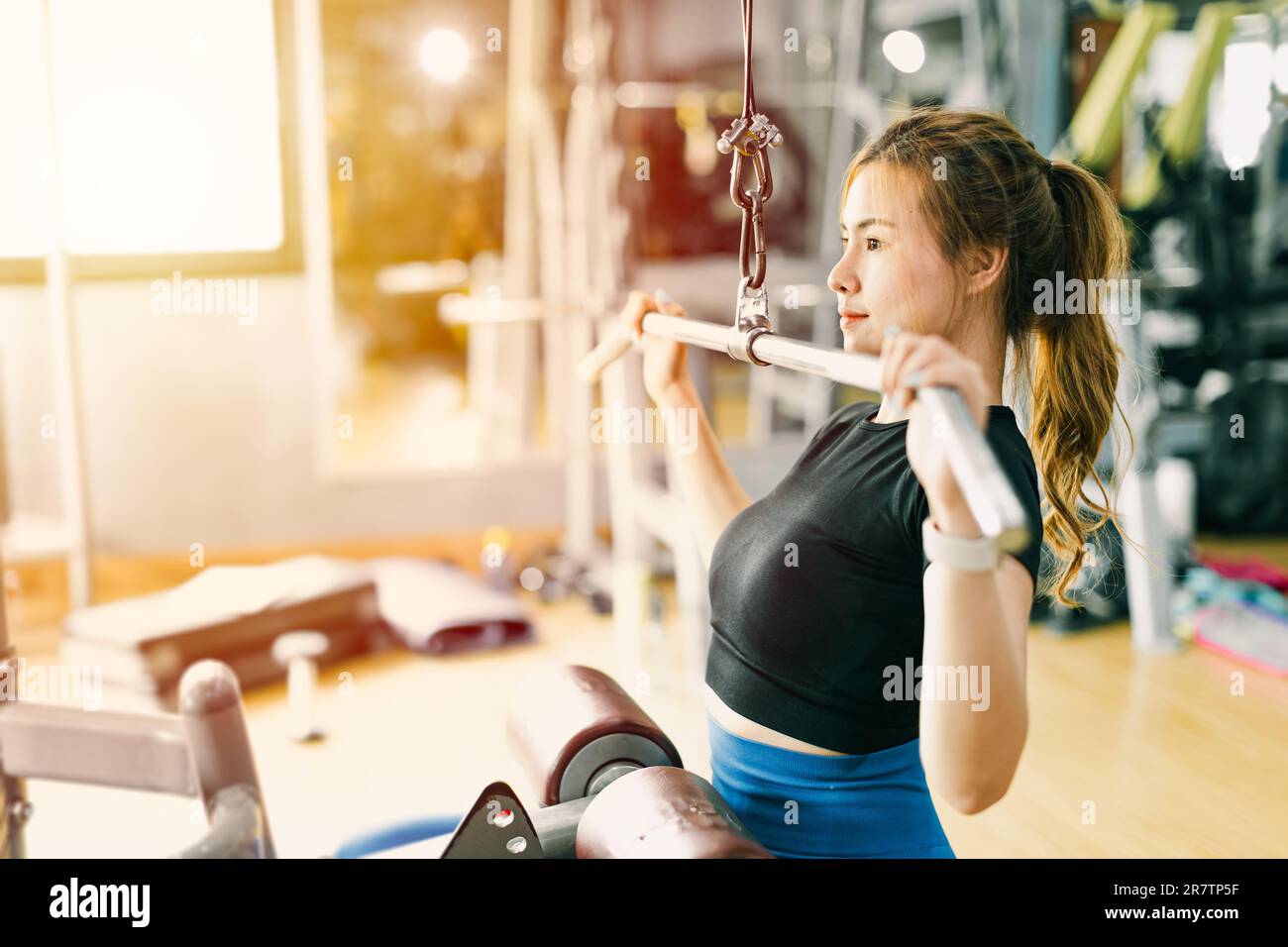 woman arms shoulder core muscle strength workout training lat pull down in fitness sport club Stock Photo
