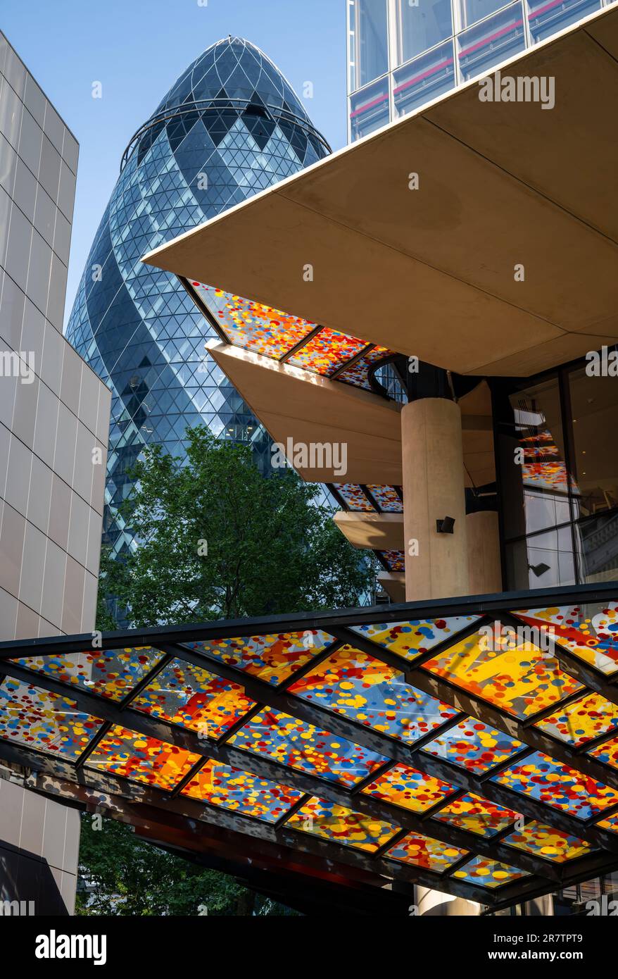 London, UK:  The colorful canopy above the entrance to 22 Bishopsgate in the City of London with the Gherkin skyscraper behind. Stock Photo