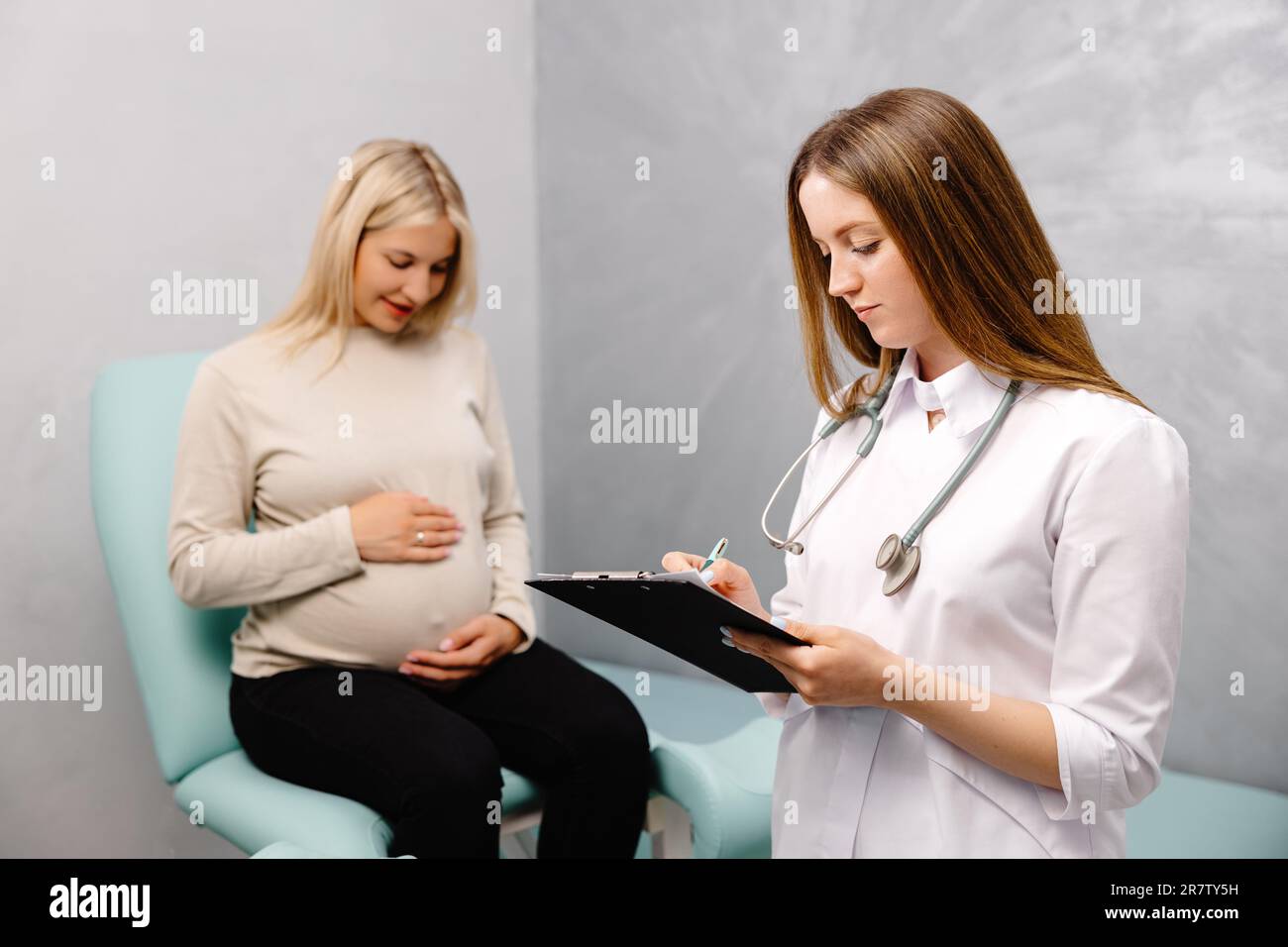 Gynecologist talking with a young female patient during a medical