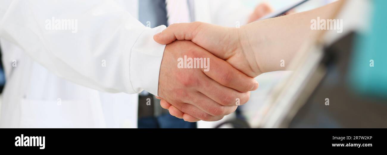 Doctor and patient shake hands in clinic. Medical care contract and ...