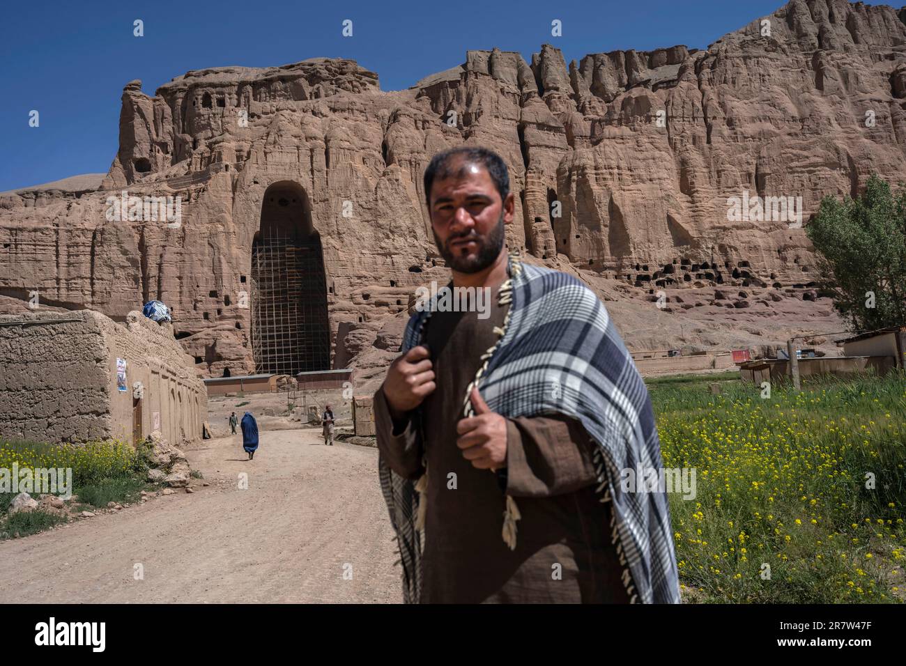 A villager pose for the picture near the niche of the giant Buddha