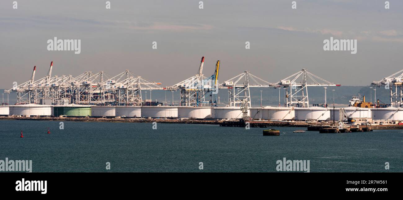 Le Havre, northern France, Europe. 2023. Cranes in the container port and storage  tanks alongside a jetty in the Port of Le Havre, France. Stock Photo